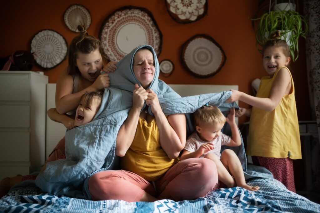 mom hides under a blanket from four children, mental health